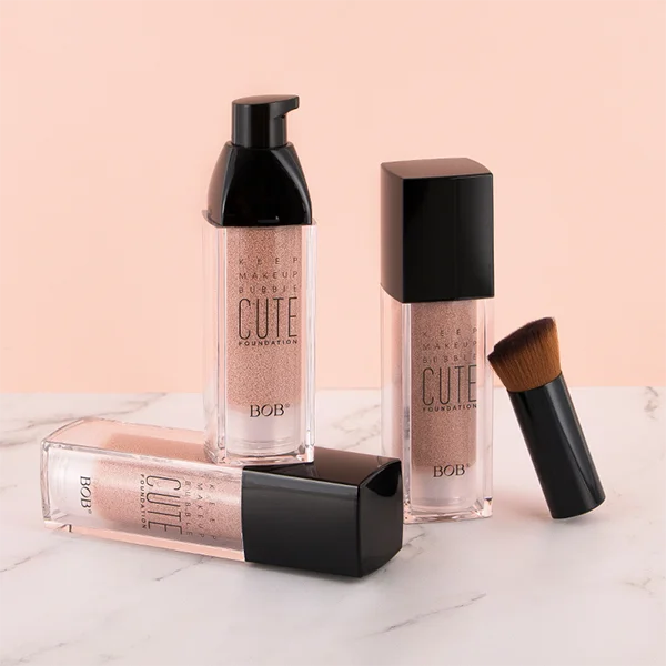 three bottles of makeup foundation with a brush