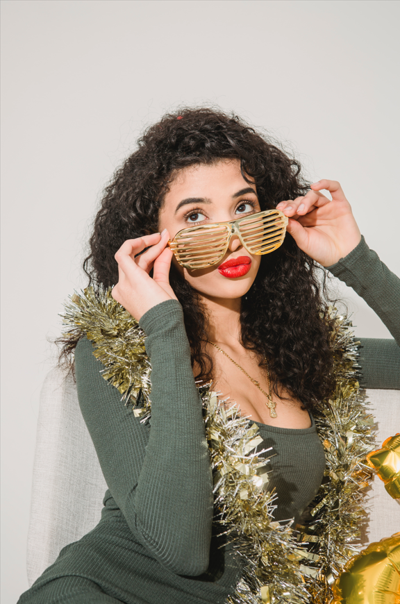 Woman in striped glasses and applying on red lipstick