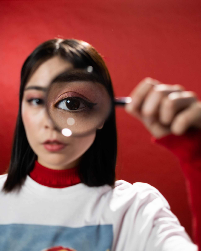 a woman holding a magnifying glass