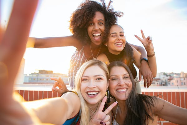 4 ladies taking a selfie happily