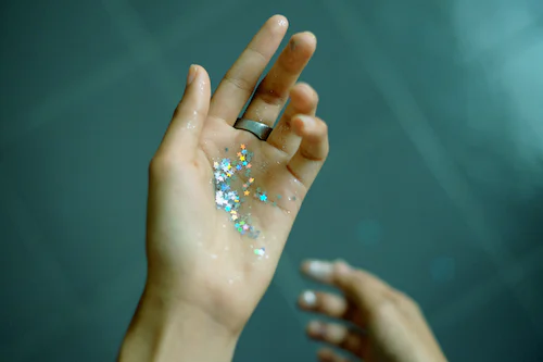 a hand applying on some shiny glitter